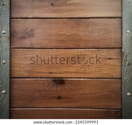 close up.a wooden door studded with iron.