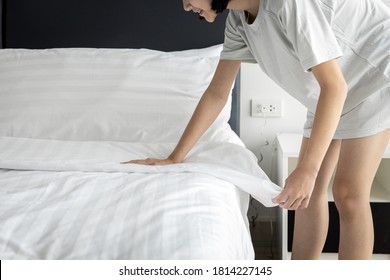 Close Up,Asian Child Girl Making Bed Arranging Blanket And Bedding In Her Bedroom After Wake Up,happy Smiling Girl Cleaning The Room,enjoy While Doing Housekeeping At Home,lifestyle,housework Concept