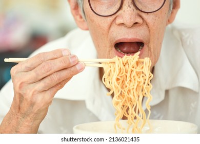 Close Up,Asian Senior Woman Opening Her Mouth To Eat Instant Noodles,junk Food,old Elderly Eating Instant Noodles,dangers Of High Sodium Diets,risk Of Heart Disease,high Blood Pressure,kidney Failure