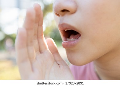 Close Up,Asian Young Woman Raised Her Hand Near Her Mouth To Whisper Or Speaks Softly And Gossip,child Girl Telling A Secret Or Talking In A Low Voice,sharing A Secret,whispering And Gossiping Concept