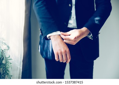 Close Up.business Man Adjusting His Cuff Links