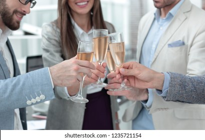 close up.glasses of champagne in the hands of the business team. - Powered by Shutterstock