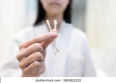 Close Up,Hand Of Asian Child Girl Holding Cotton Bud With A Lot Of Ear Wax Or Wet Cerumen After Cleaning Her Ear Canal With Cotton Swab,removing Earwax From Ears,health Care,hygiene,lifestyle Concept