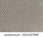 Close up of upholstery fabric with horizontal chevron pattern in brown and beige color. Chevron inverted V shape pattern seamless fabric background texture.