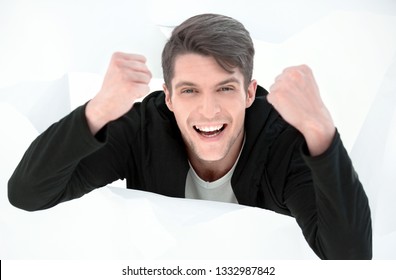 Close Up.purposeful Young Man, Breaking Through A Paper Wall.