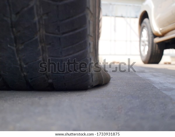 Close ups of flat tires. Selective focus\
leak tires in parking lots awaiting\
repair