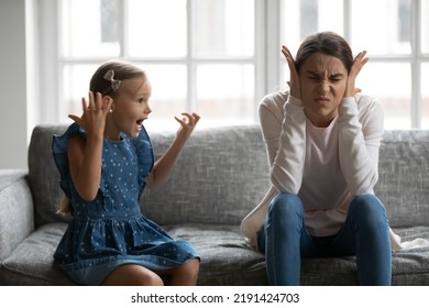 Close up upset mother covering ears, having problem with noisy naughty daughter yelling, screaming, demanding attention, frustrated mum tired of difficult child, tantrum manipulation concept - Powered by Shutterstock