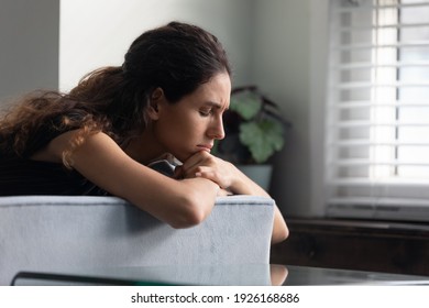 Close up upset thoughtful woman with closed eyes lying on couch alone, lost in thoughts, thinking about personal problems, frustrated unhappy young female crying, break up with boyfriend or divorce