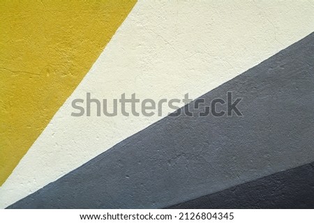 Close up of a urban geometric mural paint, wall textured background in ethnic colors.