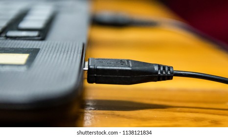 Close up USB cable, computer accessories used to transfer data from notebook or computer to external hard drive, technology today. 