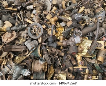 Close up used brass scrap are non ferrous metal raw materials for the recycling smelting manufactures. Waste metal can be reproducing in the recycle industries. Brass scrap background. - Shutterstock ID 1496745569