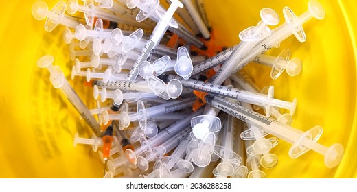 close up of the used vaccine needles in the sharp bin.  - Shutterstock ID 2036288258