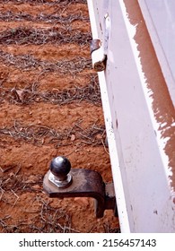 Close up of ute trailer ball with tilled red dirt in background