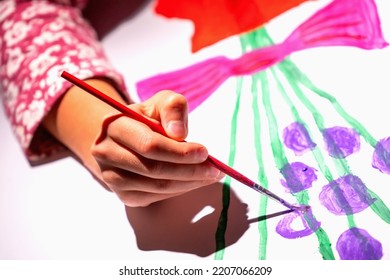 Close Uup Young Girl Girl With Brush Painting On Table In Primary School. Painting Children Lesson In Primary School. Small Table In Painting Class. Selective Focus On Hand.