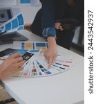 Close up ux developer and ui designer use augmented reality brainstorming about mobile app interface wireframe design on desk at modern office.Creative digital development agency