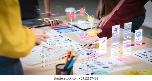 Close up ux developer and ui designer use augmented reality brainstorming about mobile app interface wireframe design on desk at modern office.Creative digital development agency - Shutterstock ID 1912867468