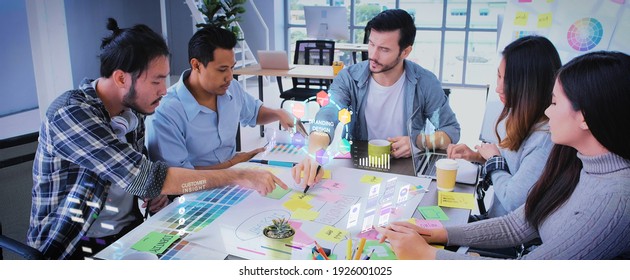 Close up ux developer and ui designer use augmented reality app brainstorming about mobile interface wireframe design on desk at modern office.Creative digital development agency - Powered by Shutterstock