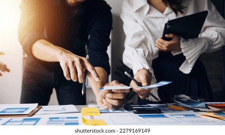 Close up ux developer and ui designer use augmented reality brainstorming about mobile app interface wireframe design on desk at modern office.Creative digital development agency - Powered by Shutterstock