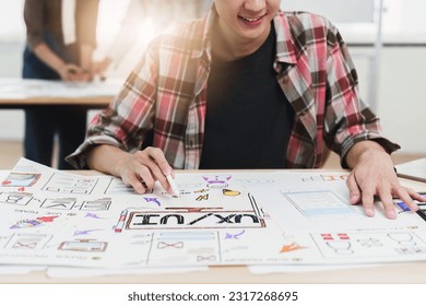 Close up ux developer and ui designer brainstorming interface wireframe design.Creative digital development agency