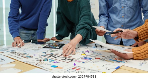 Close up ux developer and ui designer brainstorming interface wireframe design.Creative digital development agency