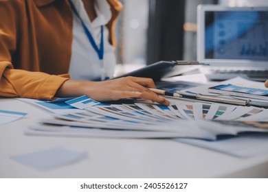 Close up ux developer and ui designer use augmented reality brainstorming about mobile app interface wireframe design on desk at modern office.Creative digital development agency