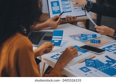 Close up ux developer and ui designer use augmented reality brainstorming about mobile app interface wireframe design on desk at modern office.Creative digital development agency
