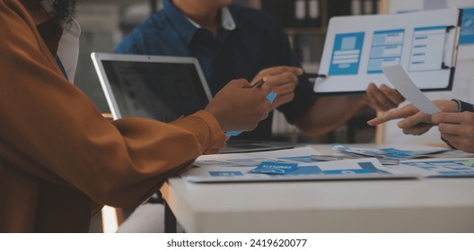 Close up ux developer and ui designer use augmented reality brainstorming about mobile app interface wireframe design on desk at modern office.Creative digital development agency