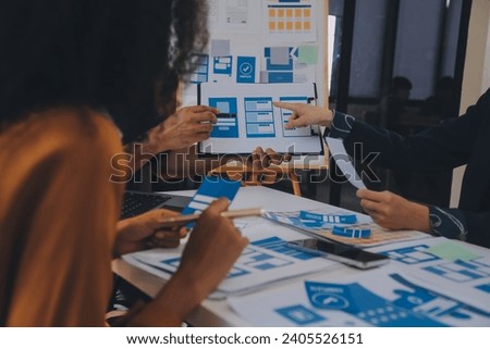 Close up ux developer and ui designer use augmented reality brainstorming about mobile app interface wireframe design on desk at modern office.Creative digital development agency