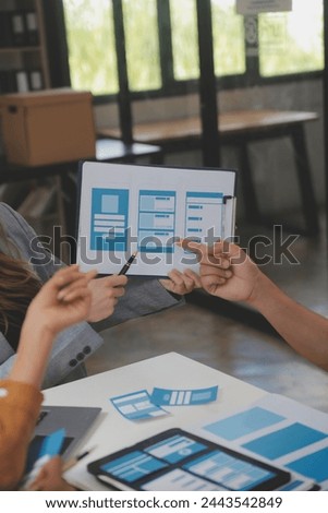 Close up ux developer and ui designer use augmented reality brainstorming about mobile app interface wireframe design on desk at modern office.Creative digital development agency