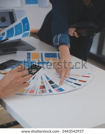 Close up ux developer and ui designer use augmented reality brainstorming about mobile app interface wireframe design on desk at modern office.Creative digital development agency
