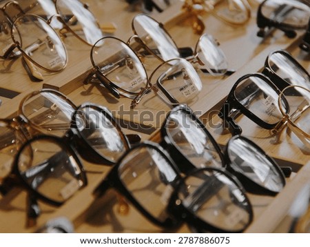 Close up of various eyeglasses and spectacles frames displayed in a row with selective focus