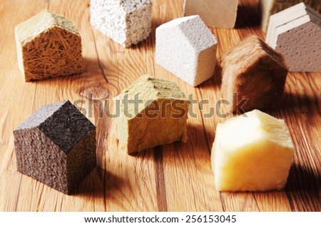 Close up Various Scattered Blocks of insulation Model Hous in Different Standing on Top of the Wooden Table