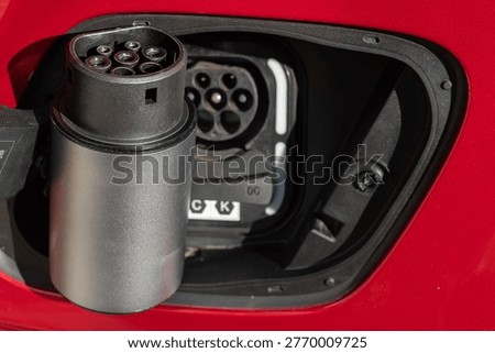 Close up of a vehicle to load apapter plug and socket to enable appliances to be plugged in and used in and electric car Type 2 CCS