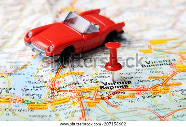 Close up of  Verona , Italy map with red pin and\
a car   - Travel concept