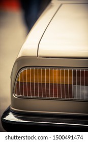 Close up vertical image of the tail light of a classical vintage car.