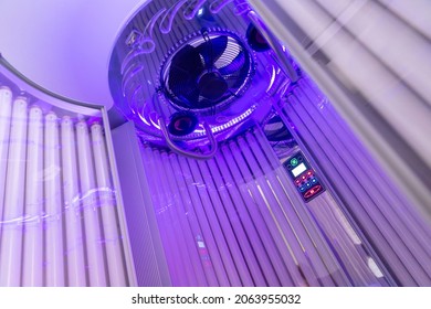 Close Up Of Vertical Solarium For Tanning Skin In Spa Salon, Ultraviolet Rays Color.