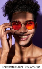 Close Up Verticale Portrait Of Latino Male In Orange Glasses. Cheerful Transgender Model Perfect Body