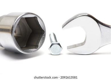 Close Up Of Very Large Open End Wrench And Ratchet Attachment With Mismatched Hex Bolt As Concept Of Not Fitting Tool And Size Difference Isolated On White Background