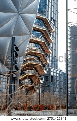 Close up of the Vessel structure and modern skyscraper facade. Detailed view of the copper colored honeycomb Vessel structure against a glass skyscraper and the Shed..