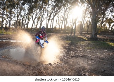 Close Up Vibrant Image Of A Female Motocross Rider Racing On A Dirt Track