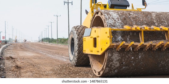 Close up of vibratory roller machine at new road construction site. Road construction.