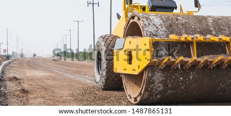 Close up of vibratory roller machine at new road construction site. Road construction.