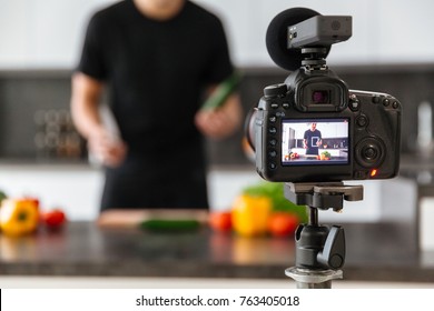 Close up of a video camera filming young male blogger at the kitchen - Powered by Shutterstock