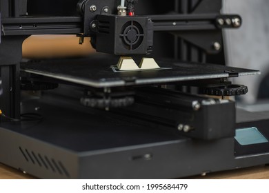 close up view of 3D printer creating plastic model on blurred background