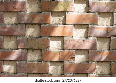 Close up view of an abstract brick wall showcasing a unique geometric pattern and texture