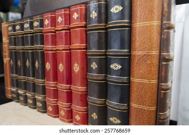 Close up view of antique books on a bookshelf. - Shutterstock ID 257768659