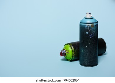 Close Up View Of Arranged Cans With Aerosol Paint Isolated On Blue