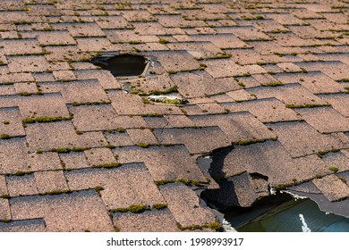 Close Up View Of Asphalt Shingles Roof Damage That Needs Repair.