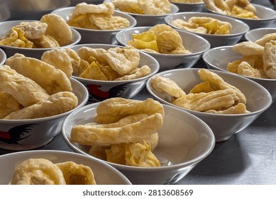 Close view of assorted golden crackers portioned into bowls for buffet service.