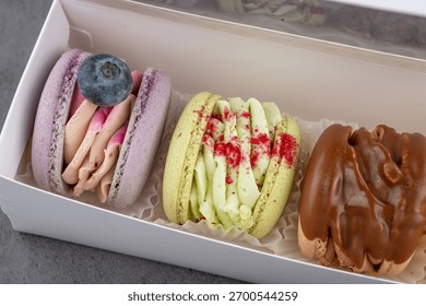 Close view of assorted macarons. A close detailed view of assorted colorful macarons with creamy textured fillings